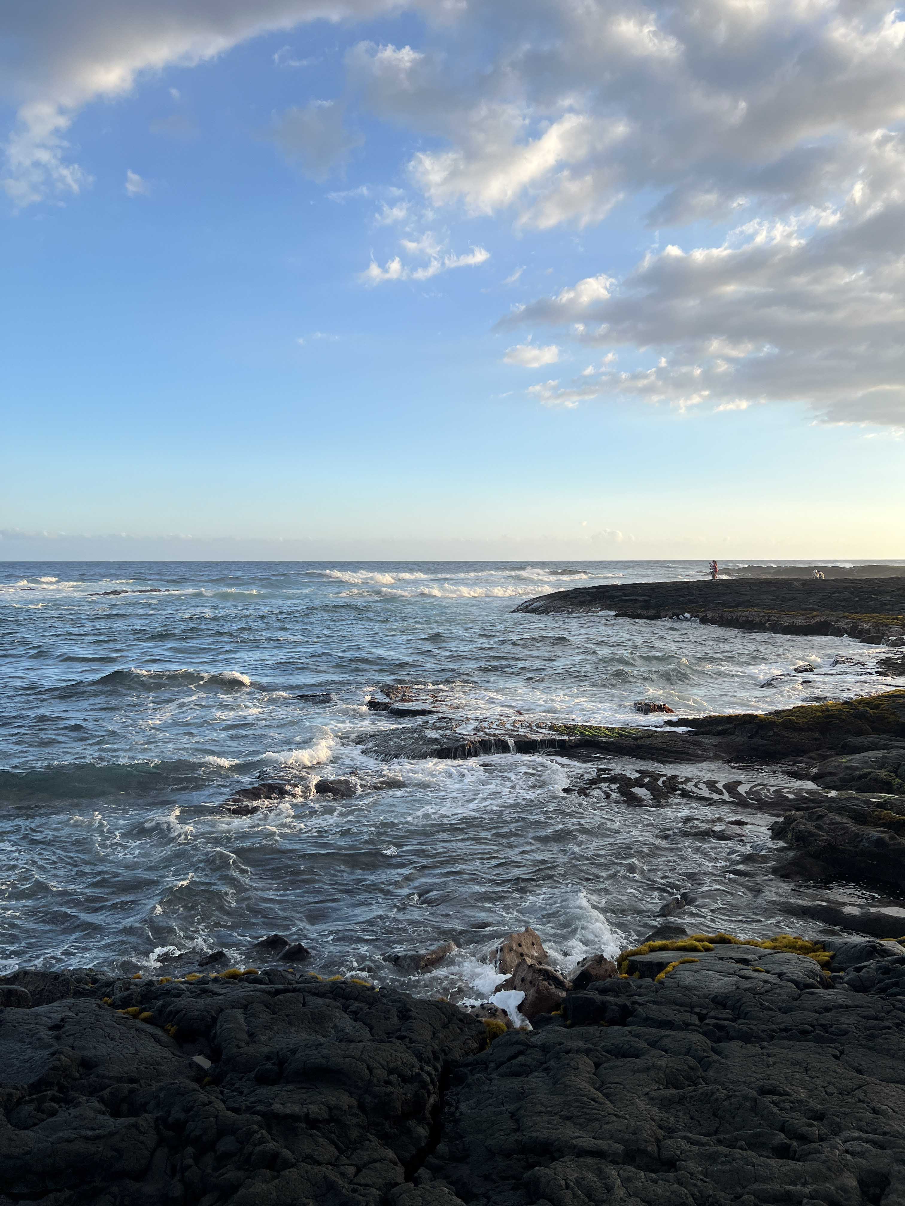 The tide surging over the basalt rock.
