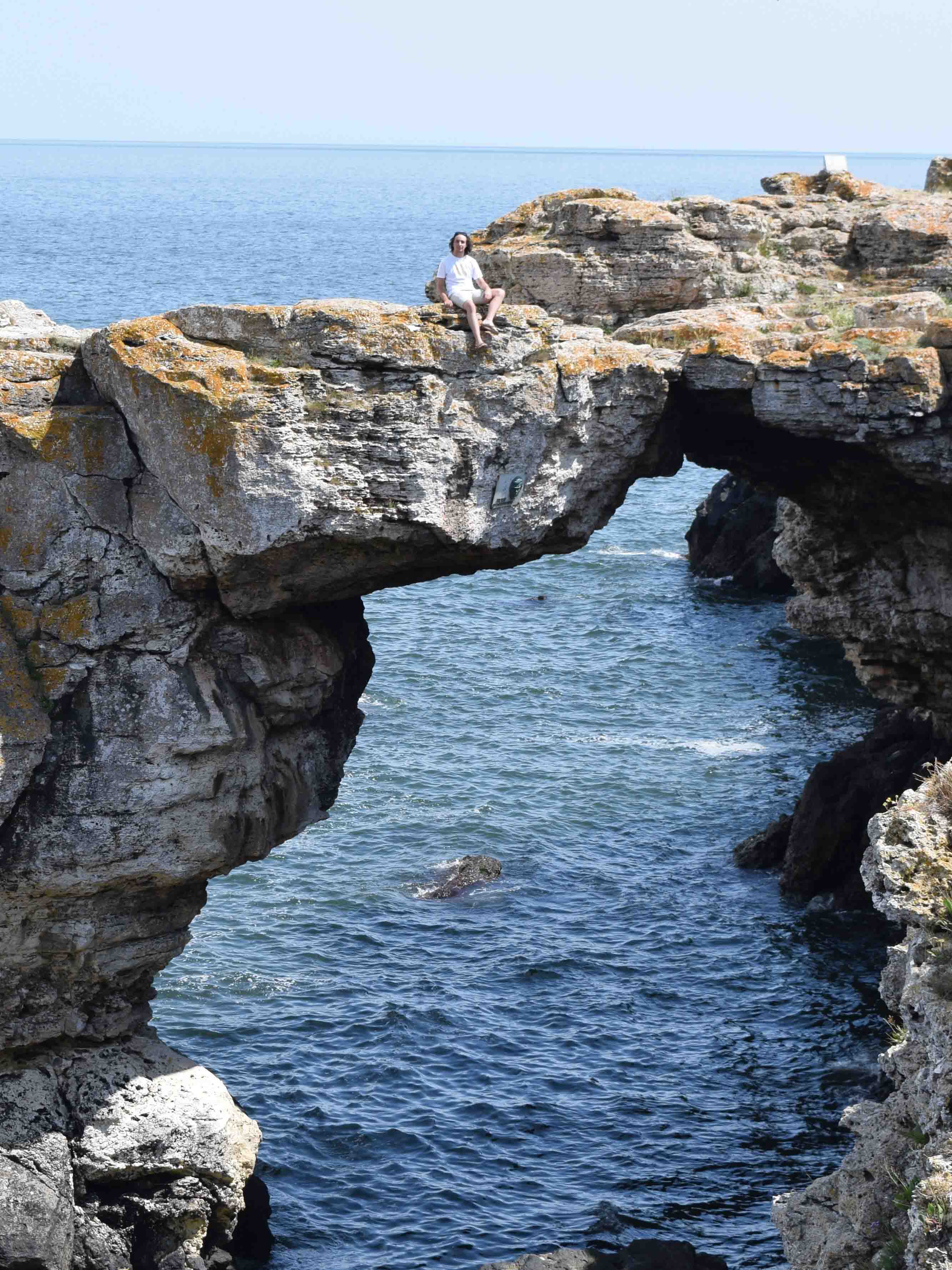 Boyan sitting on the Stone arch in Tyulenovo over the Black Sea.